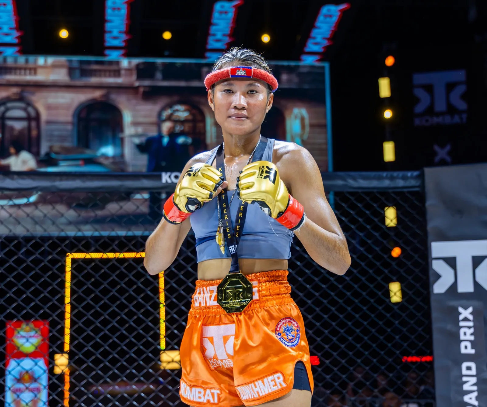 A Cambodian Kombat fighter wearing a gold medal after victory in the Kombat cage
